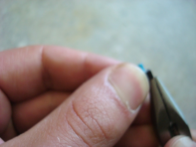 A picture of the button being bent.